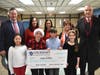 From left are Massapequa Superintendent Dr. William Brennan, student council adviser Diane Bacheller, Assistant Principal Louisa Vecchione, wish granter Joan Siedlecki and Board of Education Secretary Gary Baldinger, along with student council officers.