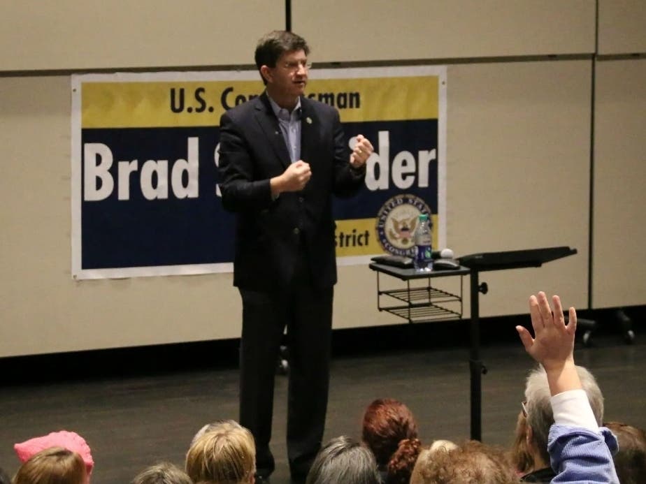 Protesters showed up outside the home of U.S. Rep. Brad Schneider (D-Highland Park), pictured speaking to constituents in Illinois' 10th Congressional District at a 2017 town hall meeting, early Saturday morning. 