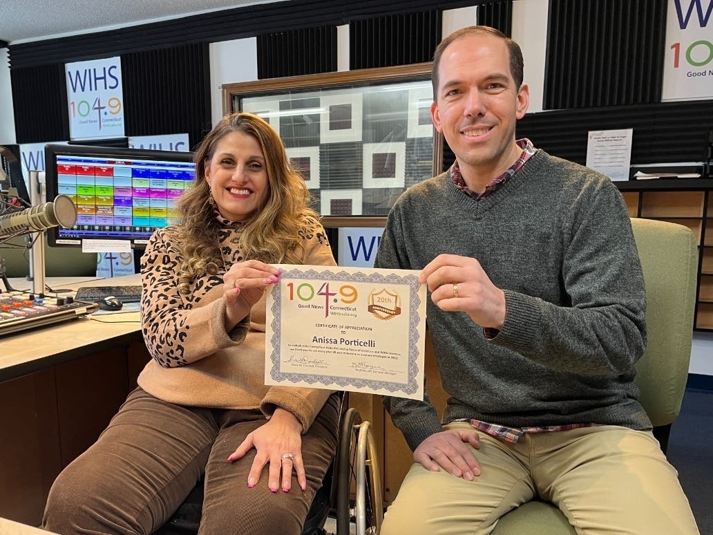 Anissa Porticelli (left) receives a certificate recognizing her 20th anniversary on the staff of WIHS 104.9 FM radio in Middletown. Shown with Anissa is WIHS General Manager Matt Harper.  