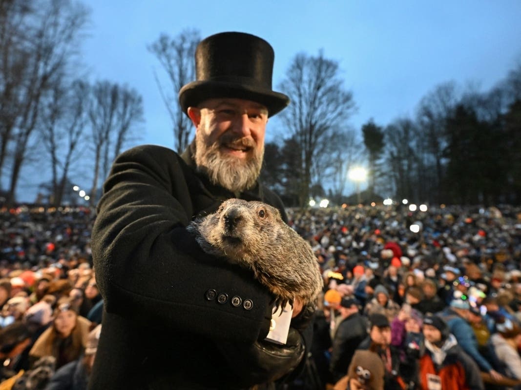 Groundhog Club handler A.J. Dereume holds Punxsutawney Phil, the weather prognosticating groundhog, during the 138th celebration of Groundhog Day on Gobbler's Knob in Punxsutawney, Pa., Friday, Feb. 2, 2024. 