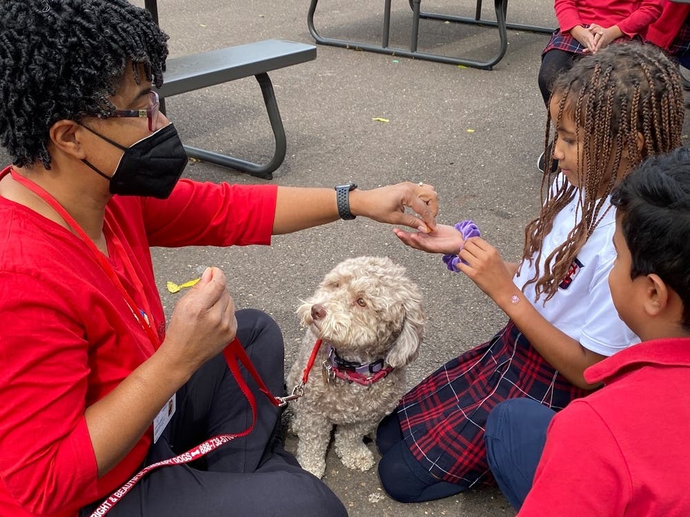 Kristine Smith and her therapy dog ,KoKo, meeting 3rd and 4th graders.