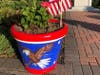 One of the new patriotic painted flower pots placed by Dedham Civic Pride at the Barnes Memorial.