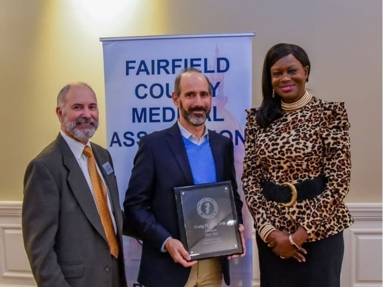 Craig Olin, MD, FACP, (center) was presented with the FCMA President’s Plaque by FCMA Board President Camelia Lawrence, MD, FACS, (right) of Hartford HealthCare and FCMA Executive Director Mark Thompson (left).