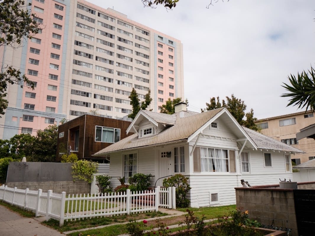 A high-rise apartments behind single-family homes near Wilshire Boulevard and 6th Street in Santa Monica on May 24, 2023. 