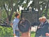 Mayor Chris Alahouzos accompanied by Vice Mayor Jacob Karr and Commissioner Costa Vatikiotis unveil the historic marker for the 1915 city hall building.