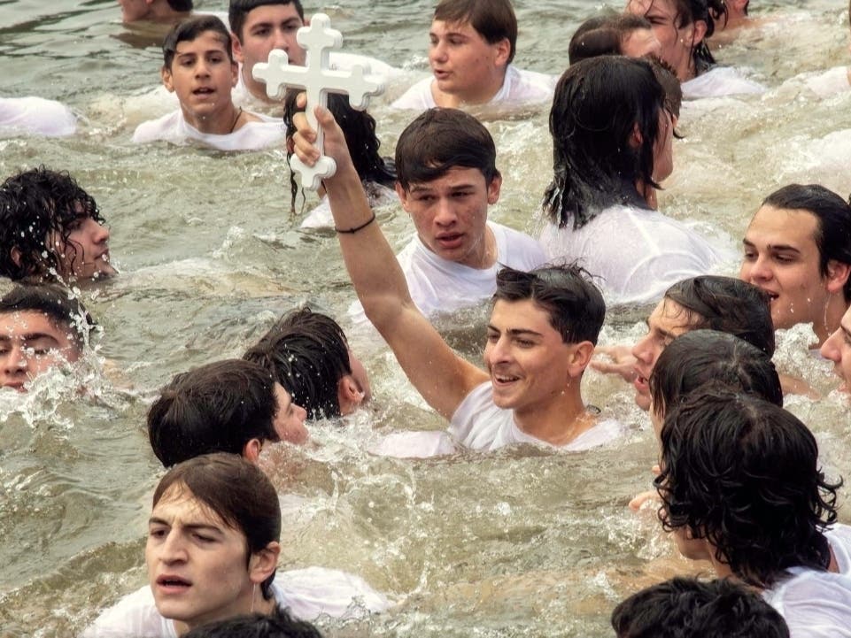 Alexander Makris, 16, of New Port Richey, retrieves the Epiphany cross in 2022.