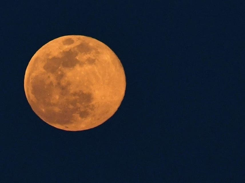 The super pink moon rises Monday over Connecticut. The pink moon got its name because the April full moon occurs at the same time the pink wildflower phlox blooms in North America. 
