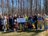 The “early arrivers” for the clean-up pose for a photo with Commissioner Bette Jane Kowalski (kneeling left of sign). More than 30 volunteers came out to help clean up Nomahegan, one of Union County’s most beautiful parks.