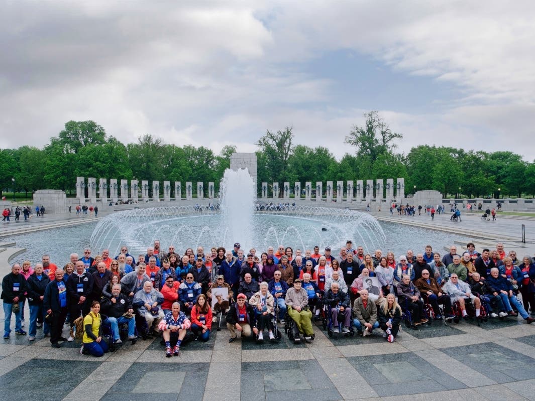 Vietnam and Korean War veterans, with Honor Flight Long Island guardians and officials, at Washington, D.C., World War II Memorial, on May 4.