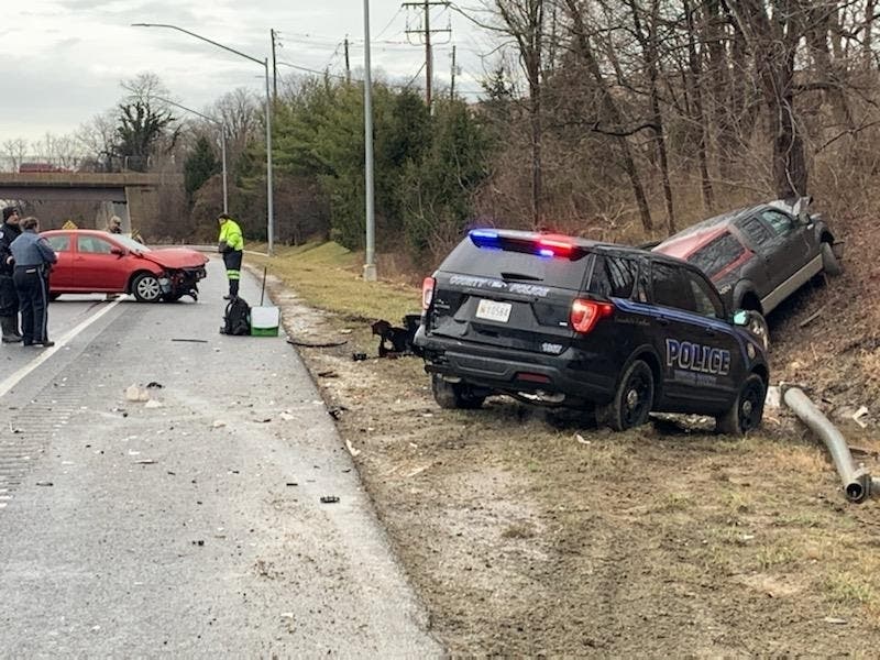 The police vehicle had its emergency lights activated when it was hit. The officer was uninjured. 