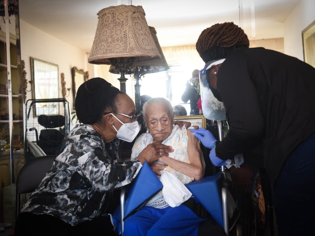 Sarah Butler, who just just turned 108 years old, receives the Johnson & Johnson vaccine from the FDNY's homebound vaccination program at her home in Harlem on April 6, 2021. Vaccination rates have risen in Harlem during the last few weeks of summer.