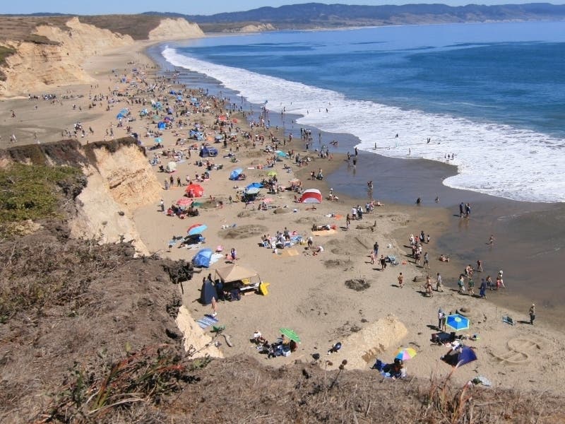 Visitors enjoy Drakes Beach on the Point Reyes National Seashore during a sunny day.