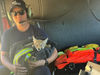 A firefighter from Cal Fire's Station 17 poses for a photo with a rescued coyote pup on Thursday, July 4, 2024.