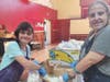 AIM women Jennifer (left) and Victoria (right) package flour for clients of Second Chance Foods in Brewster.