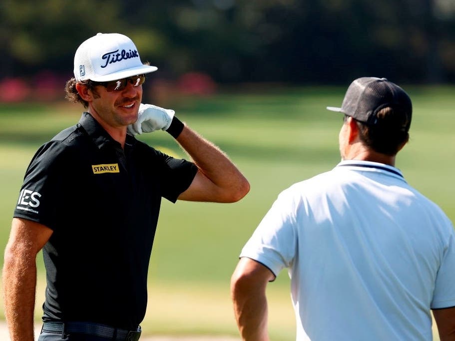 Lanto Griffin, who played golf at VCU, with his coach on the range during a practice round prior to the Masters at Augusta National Golf Club on April 6.