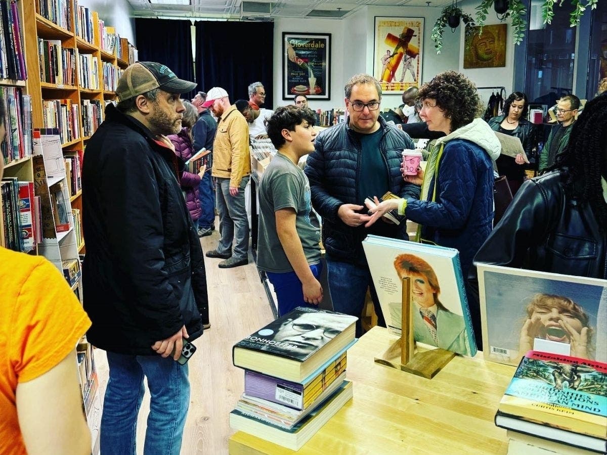 Saturday's grand reopening of Mojomala attracted many customers purchasing vinyl records, books, comics and other merchandise.