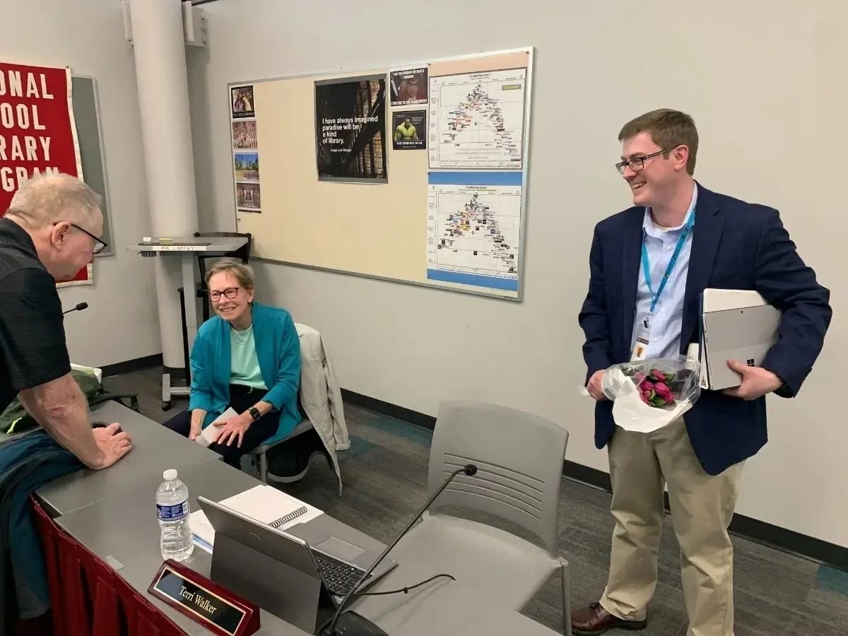 Erik Held leaves the meeting room in May 2023 after his last day as president of the Hinsdale High School District 86 board. Next to him is member Kathleen Hirsman. Both did not run again.