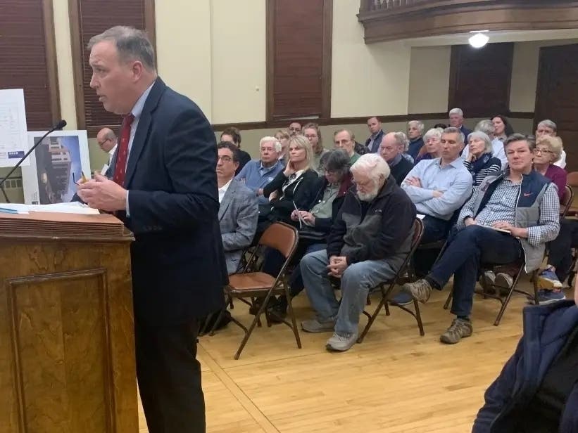 Tim Foley, an attorney for the developer of a four-story apartment building in La Grange, said Monday the company was working to lease land from ComEd for parking. He is seen here speaking at a public hearing in April.
