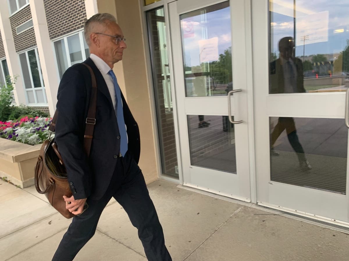 Joseph Perkoski, an attorney with Robbins Schwartz, enters Hinsdale South High in June, just in time for a closed school board session. He is the main lawyer representing District 86. Legal costs have surged since his firm got the district's business.