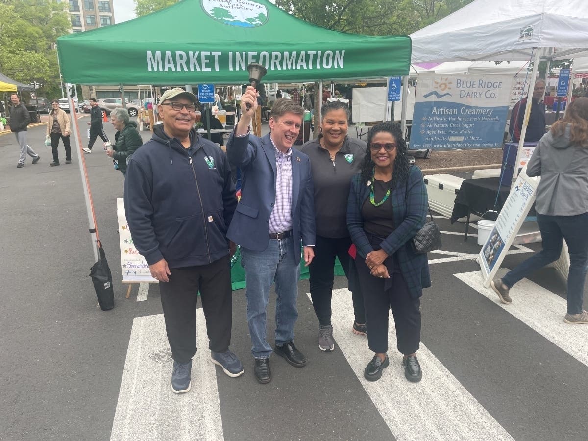 From left, Bill Bouie, Hunter Mill member of the Park Authority Board; Hunter Mill Supervisor Walter Alcorn; Fairfax County Park Authority Director Jai Cole; and Del. Karen Keys-Gamarra (D-7th) ring in the farmers market season in Reston on Saturday.