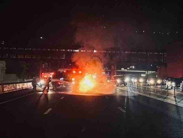 Fairfax County Fire & Rescue personnel work to extinguish a car fire late Sunday night in the westbound lanes of I-66 prior to the Nutley Street exit in Fairfax County.