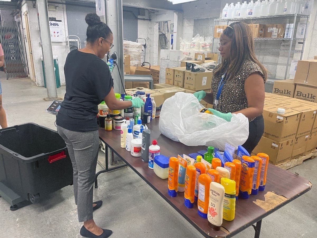 From left, Aprile Pritchet and Ayiama Cickete, the Metropolitan Washington Airports Authority's social impact manager and diversity outreach specialist, respectively, sort through items discarded by travelers at Reagan National Airport checkpoints.