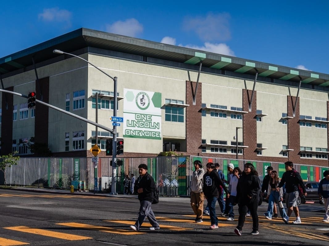 Students cross the street in front of Lincoln High School on Oct. 23 2023. 