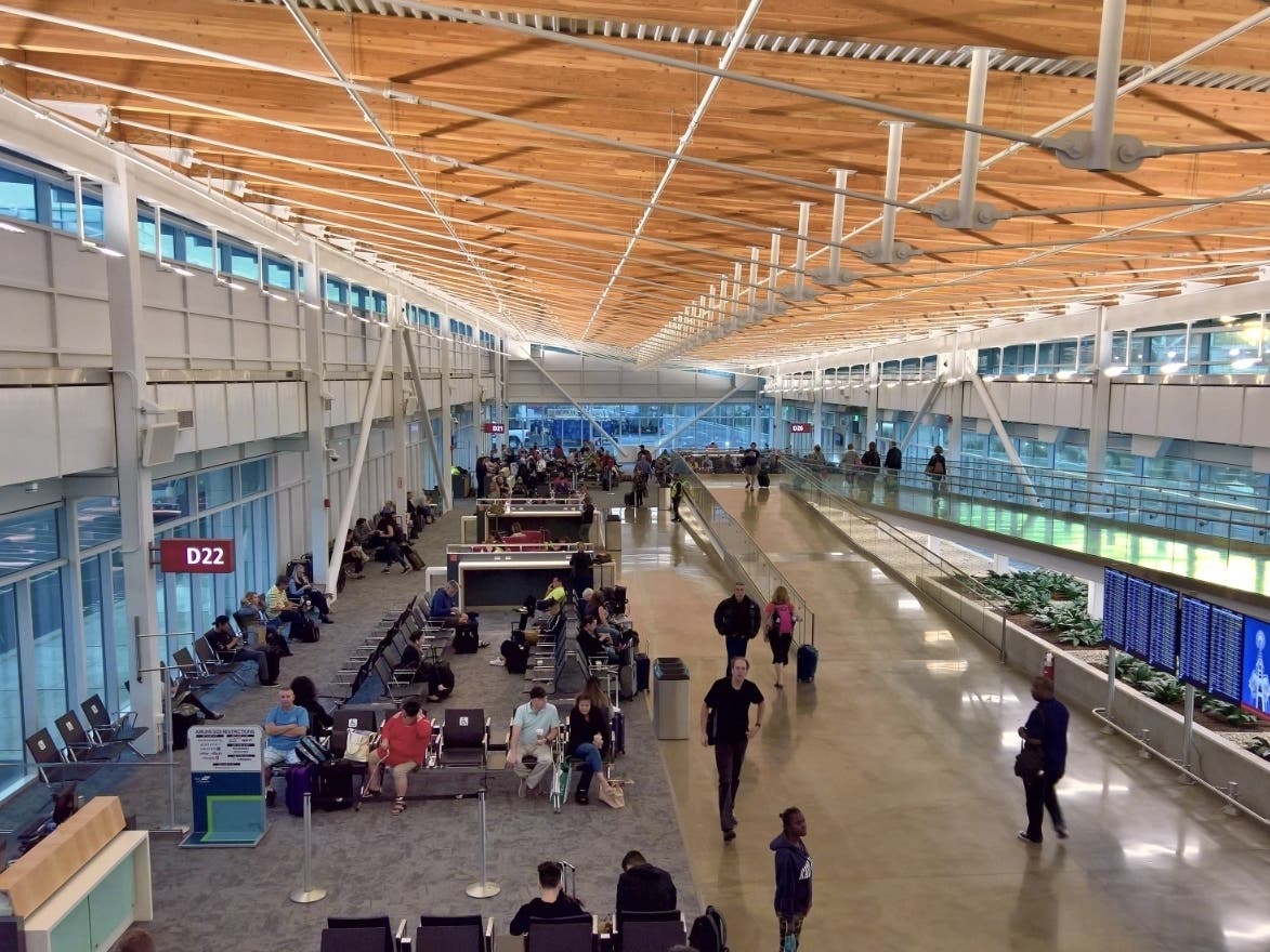 This pre-pandemic file photo of Sea-Tac shows a concourse with much fewer masks, and much less social distancing than you might expect to see today. 