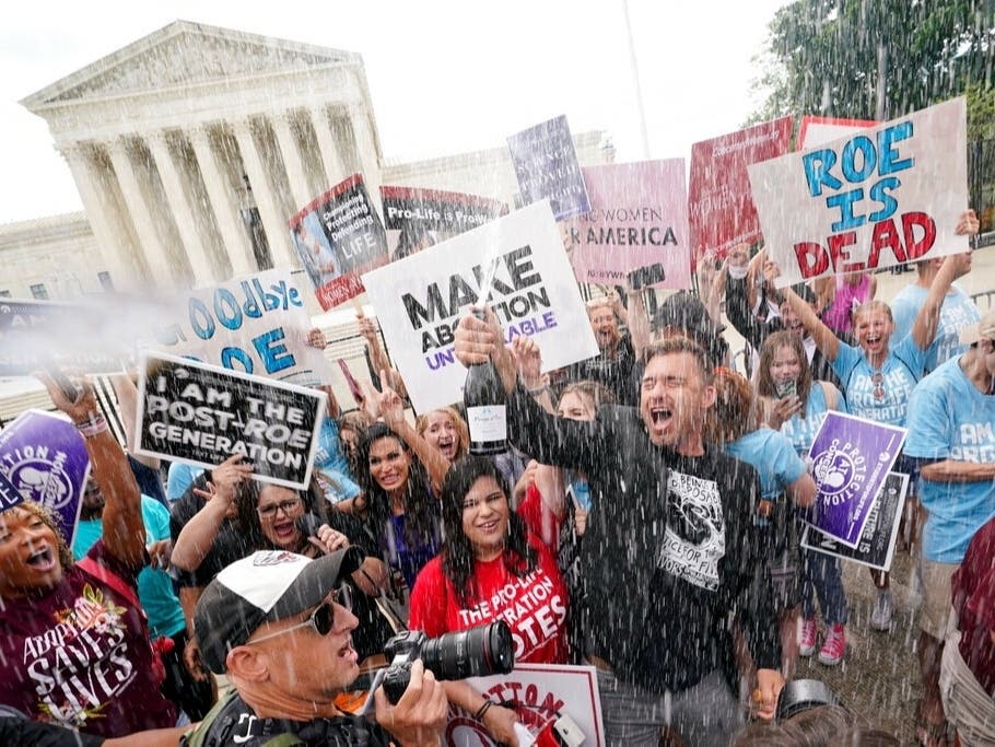 Anti-abortion protesters celebrate Friday outside the Supreme Court after justices ended constitutional protections for abortion that had been in place almost 50 years — a decision by its conservative majority to overturn landmark abortion cases.