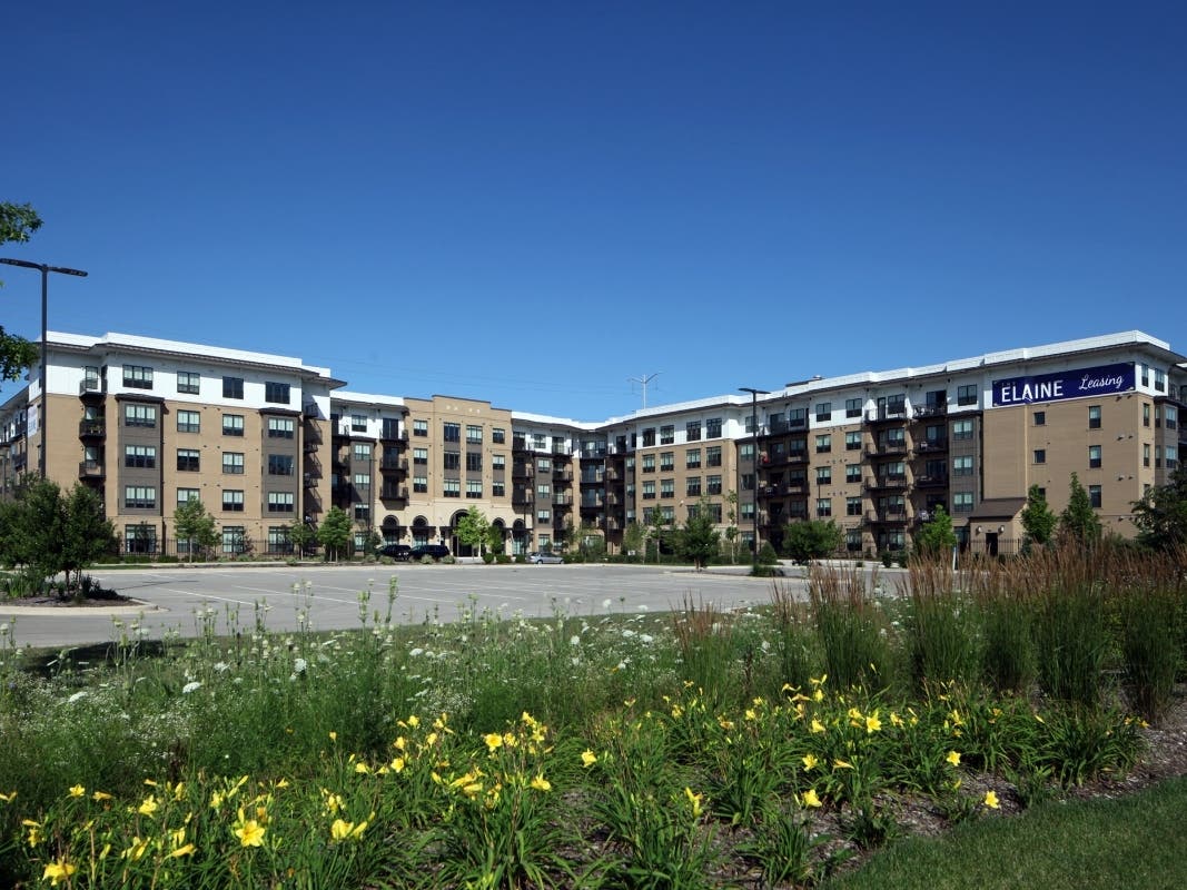 The five-story residence features wood frame construction wrapped around a six-story, precast parking deck that accommodates 642 vehicles.