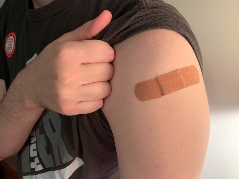 A band-aid placed on an arm after receiving a COVID-19 vaccine.