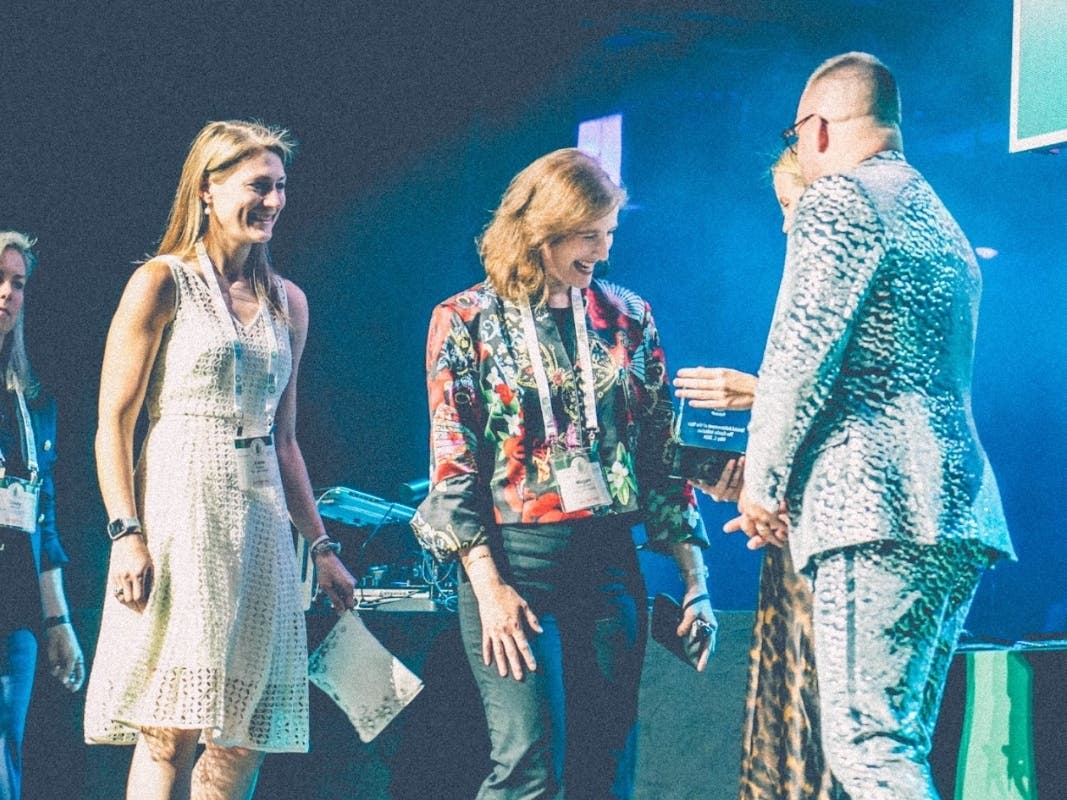 Megan Abraham (center) joined by board members of The Goldie Initiative, Katie Kazas and Cindy Malone, receives award from CREA co-chairs. Photo credit: Eric Masi