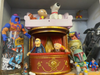 A Muppets' playset sits on a shelf along with Baby Stewie.