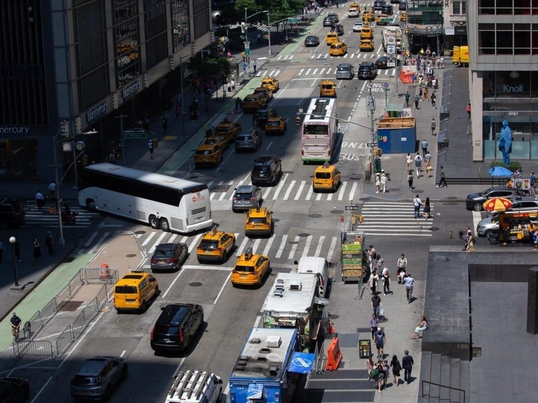 Traffic moves up Sixth Avenue in Midtown, June 18, 2024. 