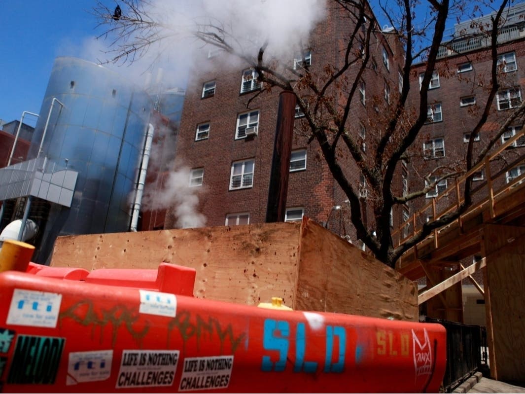 NYCHA workers installed pipes in the ground to try and divert steam from entering a Jacob Riis Houses building, July 2, 2024. 