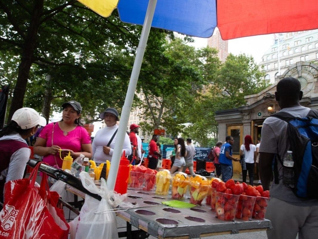 A vendor sells fruit near an entrance to Battery Park, Aug. 1, 2024.