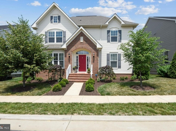 A home for sale in Ashburn's Goose Creek Preserve includes a home gym, a private office, and a crafting room with a barn door. 