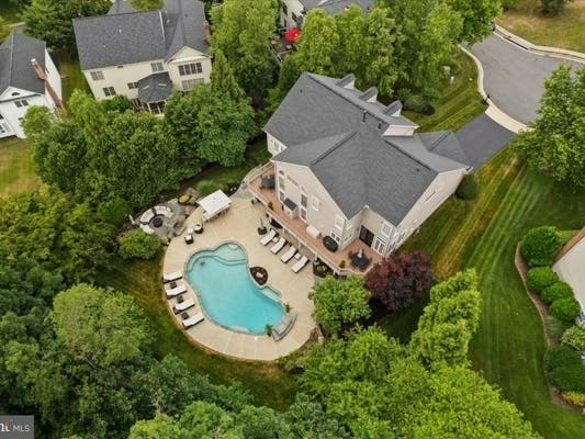 This week's featured homes for sale around Northern Virginia include properties with pools and fire pits, perfect for summer nights. A home for sale in Ashburn includes a heated freeform pool with a waterfall feature, and an in-home speaker system.