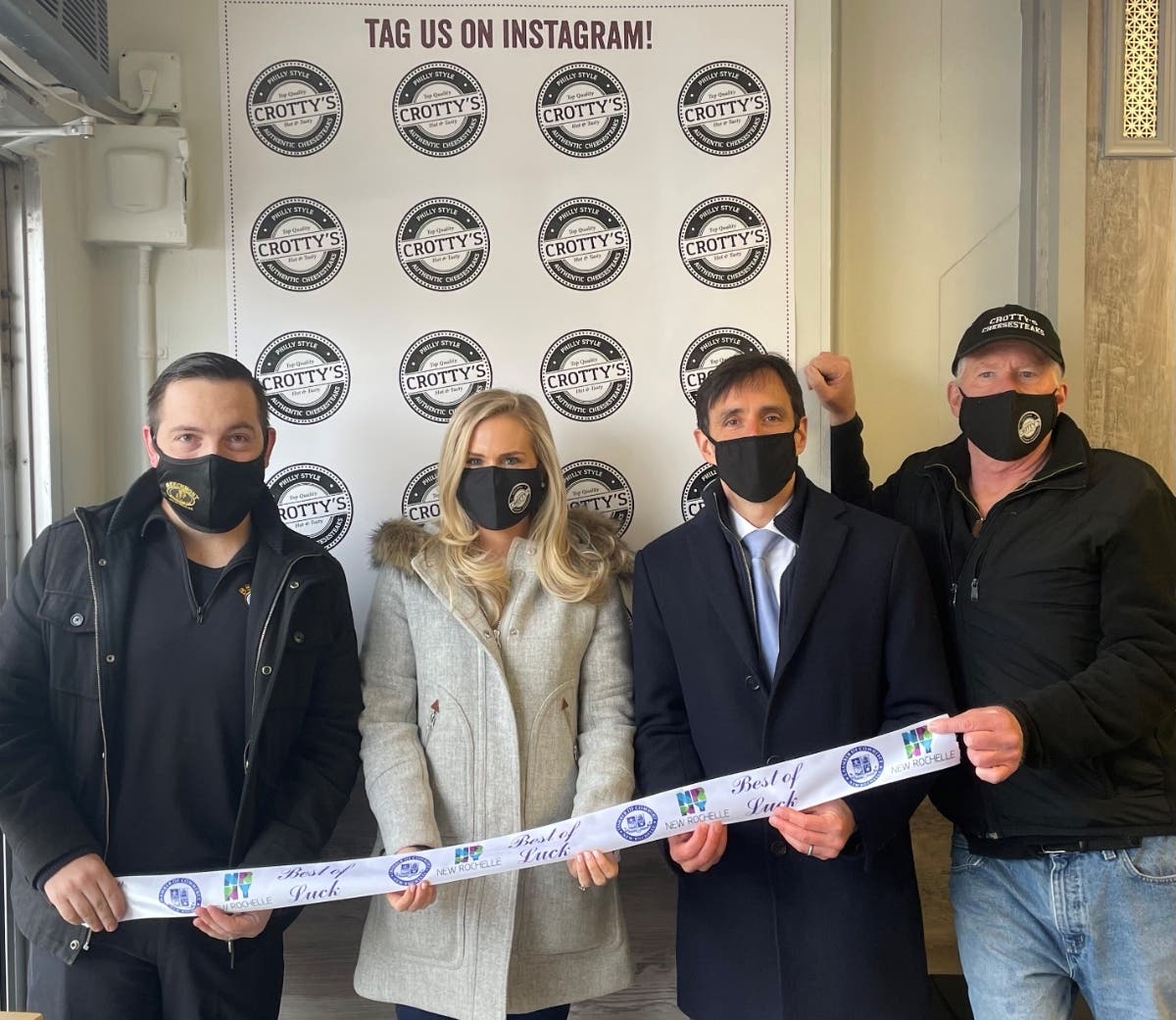 Mayor Noam Bramson, New Rochelle Chamber President Rob Hayes and co-owners Lindsay Walsh and Joe Crotty at the February 24 ribbon cutting for Crotty’s Cheesesteaks.