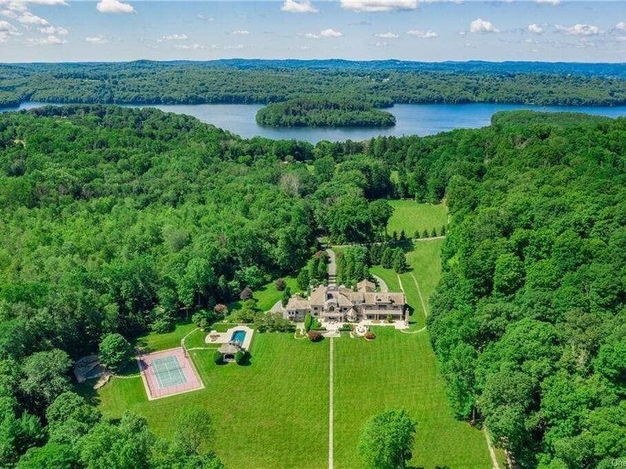 The pool and tennis complex is a discrete distance from the main house.