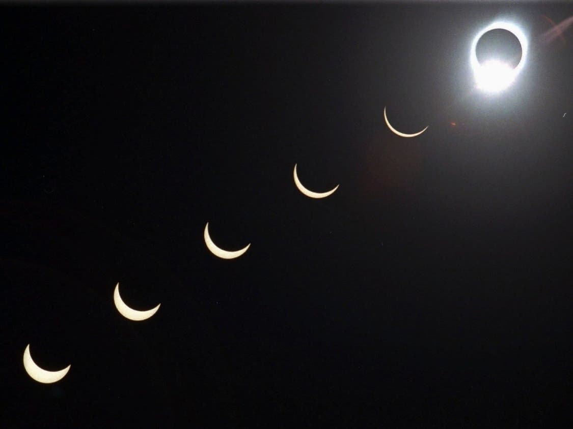 The progression of a total solar eclipse is seen in a multiple exposure photograph taken in 5-minute intervals, with the moon passing in front of the sun above Siem Reap in northwestern Cambodia.