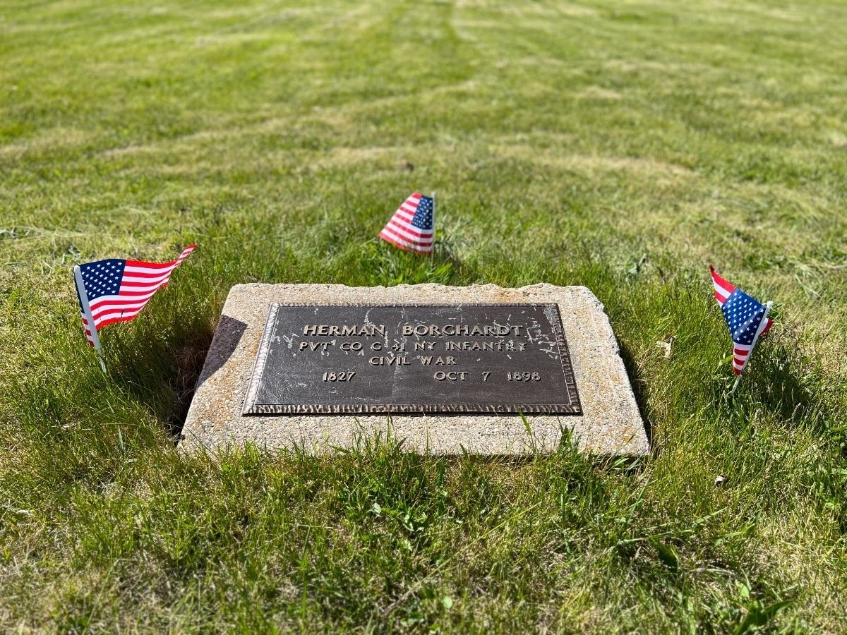 Three flags were placed by Judy Klimt Houston at Milwaukee County's poor farm cemetery on Memorial Day 2023 to honor the civil war veterans once buried there. Just one of the soldier's graves is marked, but Houston says she discovered two others. 