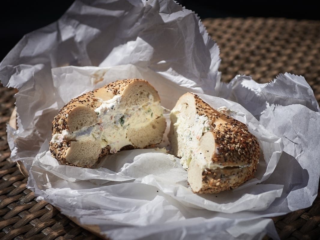 An everything bagel with scallion cream cheese at an undisclosed bagel location.