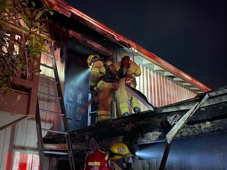 A fire damaged a two-story house in Irvine Wednesday evening with the Red Cross assisting the four residents in finding alternative housing.