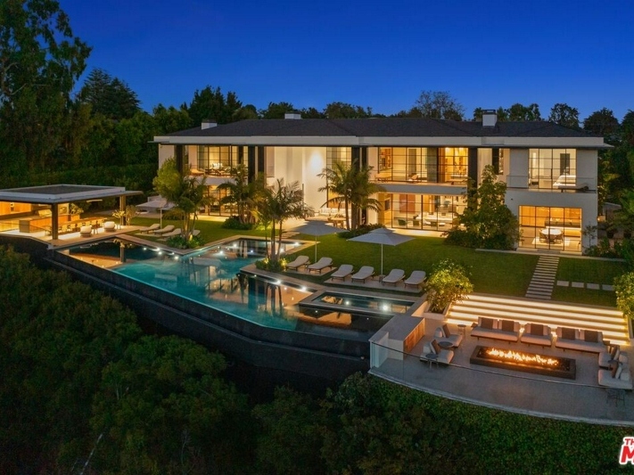 This nearly 23,000-square-foot Santa Monica home is on the market for $69 million and boasts a karaoke room, indoor basketball court, movie theater, library, wine cellar and resort pool. 