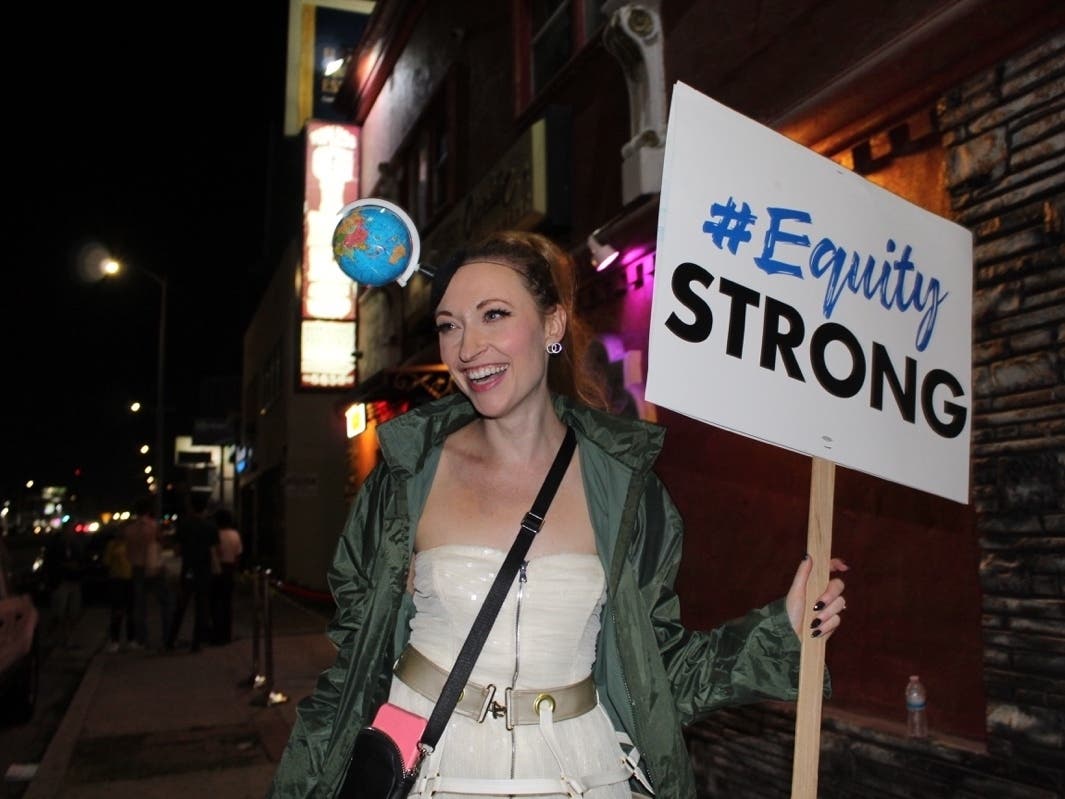 Star Garden dancer and actress Reagan poses on the picket line outside Star Garden Topless Dive Bar in North Hollywood.