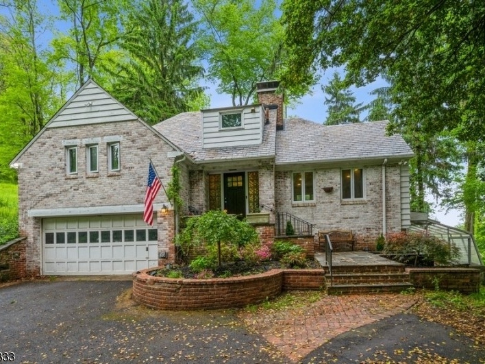 This two-bedroom house for sale comes with a wood-burning fireplace, a walk-up attic, a greenhouse and a large flagstone patio.