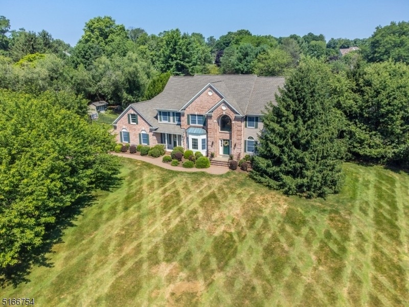 This four-bedroom Colby Farms colonial greets you with a paver driveway and a canopy of cherry trees.