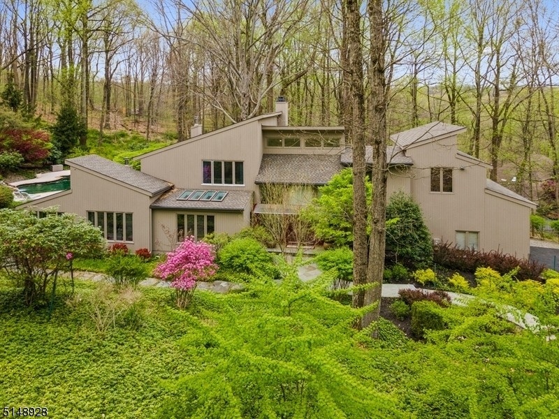 This four-bedroom home is listed for $1.2 million and includes a large deck with a heated pool, waterfall and hot tub.