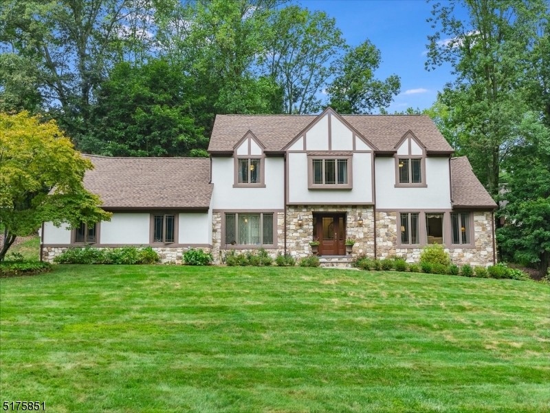 This five-bedroom home sits on more than an acre of private land and has a cozy family room with a fireplace and a wall of windows.